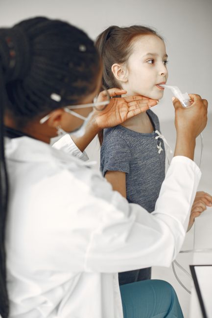 Asian girl receiving medical care from doctor in clinic
