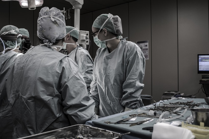 Medical professionals performing pancreatic surgery in an operating room